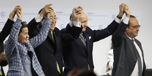 Foreign Affairs Minister and President-designate of COP21 Laurent Fabius (C), raises hands with Secretary General of the United Nations Ban Ki Moon (2-L) and France's President Francois Hollande (R) after adoption of a historic global warming pact at the COP21 Climate Conference in Le Bourget, north of Paris, on December 12, 2015. Envoys from 195 nations on December 12 adopted to cheers and tears a historic accord to stop global warming, which threatens humanity with rising seas and worsening droughts, floods and storms. AFP PHOTO / FRANCOIS GUILLOT / AFP / FRANCOIS GUILLOT        (Photo credit should read FRANCOIS GUILLOT/AFP/Getty Images)